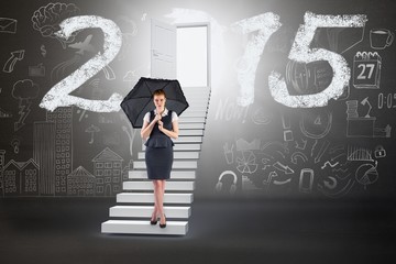 Poster - Composite image of pretty redhead businesswoman holding umbrella