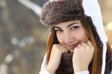 Wall Mural - Beauty woman face portrait warmly clothed in winter