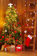 Wall Mural - Decorated Christmas tree and ladder on wooden wall background