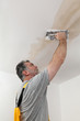 © sima - Worker, mason repairing plaster at ceiling with trowel