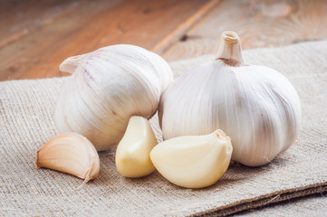 Organic garlic whole and cloves on the wooden background