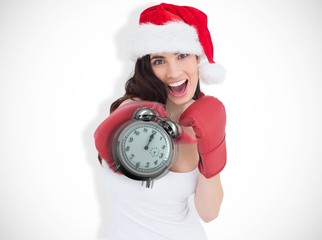 Poster - Composite image of festive brunette in boxing gloves punching