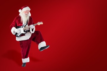 Poster - Composite image of santa claus has fun with a guitar
