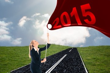 Poster - Composite image of businesswoman pulling a chain