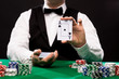 © Syda Productions - holdem dealer with playing cards and casino chips