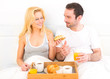 © Production Perig - Portrait of a couple having breakfast in bed