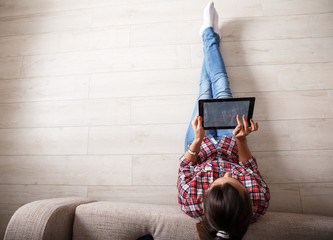 Wall Mural - Young couple using tablet.Relaxing.