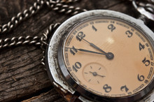 Old Pocket Watch On A Rustic Vintage Wooden Background