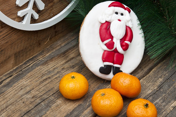 gingerbread cookie with mandarins on an old wooden Christmas bac