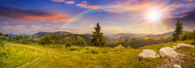 Boulders On Hillside Meadow In Mountain At Sunset With Rainbow