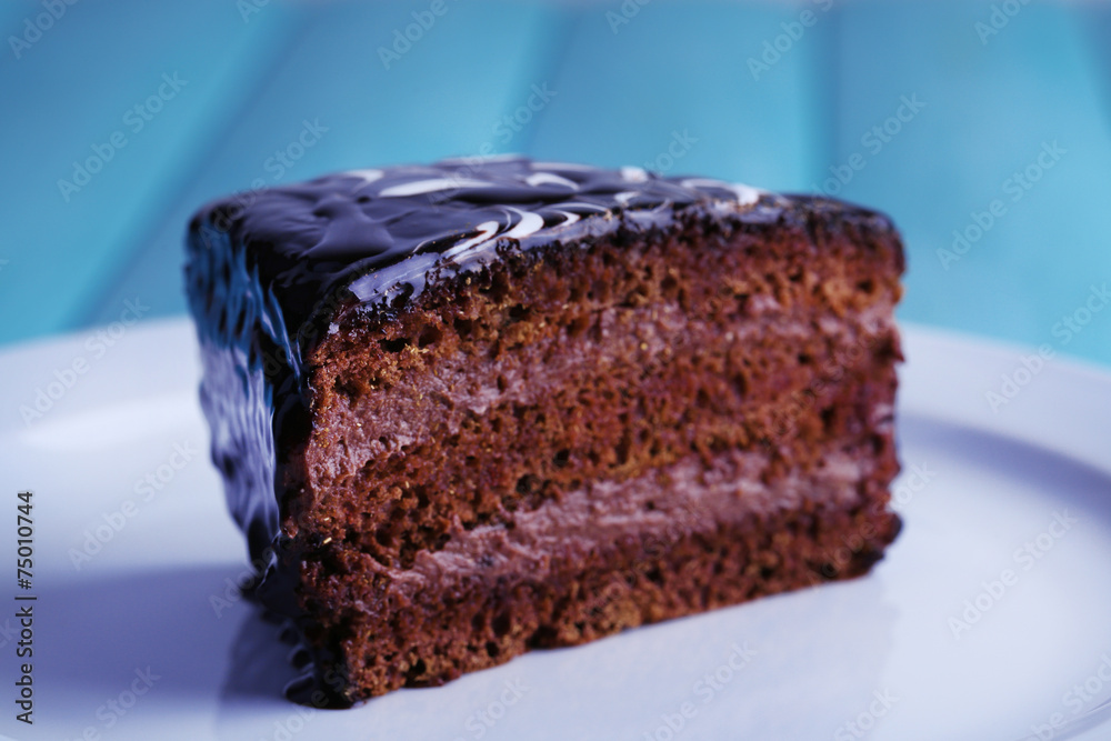 Delicious chocolate cake on plate on table close-up