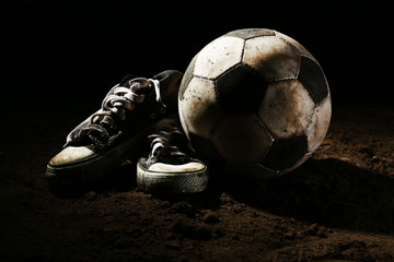 Wall Mural - Soccer ball on ground on dark background