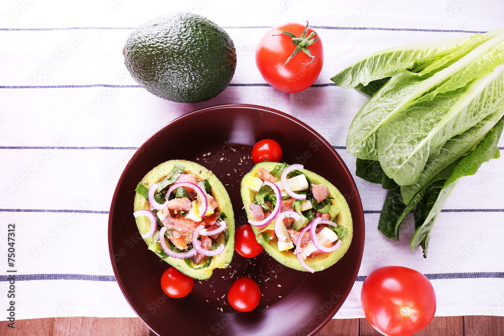Tasty salad in avocado on plate table close-up