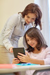 © Syda Productions - little girl with teacher and tablet pc at school