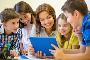 Canvas Print - group of kids with teacher and tablet pc at school