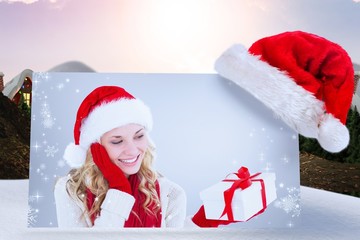Poster - Composite image of happy festive blonde with gift