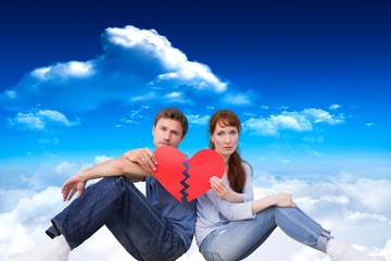 Poster - Composite image of couple holding a broken heart