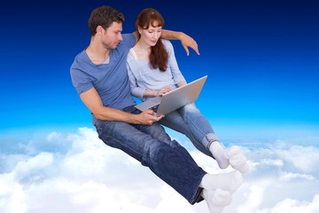 Poster - Composite image of couple using laptop at home