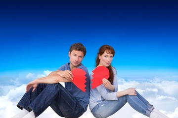 Poster - Composite image of couple holding a broken heart