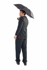 Poster - Businessman looking up while holding black umbrella