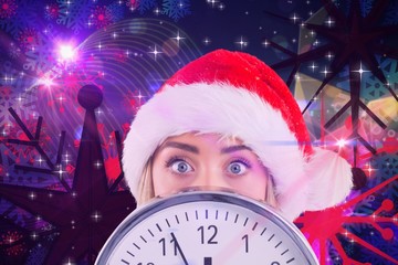 Poster - Composite image of festive blonde showing a clock