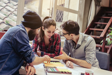 Teamwork. Three young architects working on a project