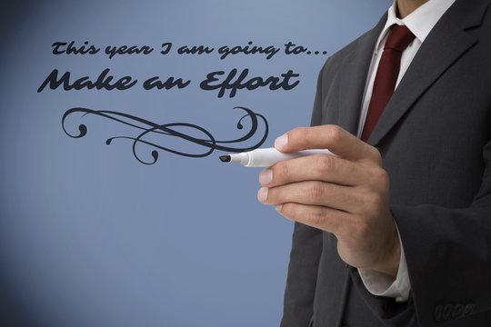 Composite image of classy businessman holding a marker