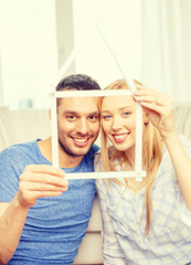 Wall Mural - smiling couple with house from measuring tape