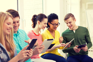 Wall Mural - smiling students with tablet pc at school