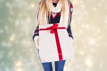 Poster - Composite image of festive blonde holding a gift