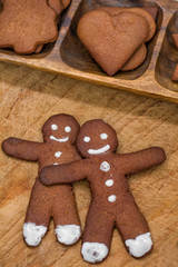 two gingerbread man and christmas gingerbread on wooden backgrou