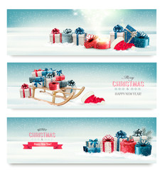Poster - Three Christmas banners with presents and a sleigh. Vector.