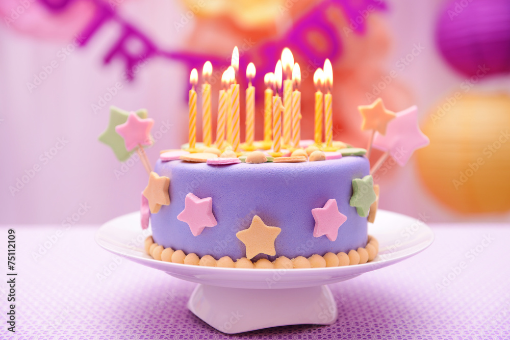 Delicious birthday cake on table on bright background