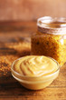 Dijon Mustard in glass jar and mustard sauce in glass bowl