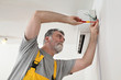 © sima - Electrical installation of air conditioner, electrician at work