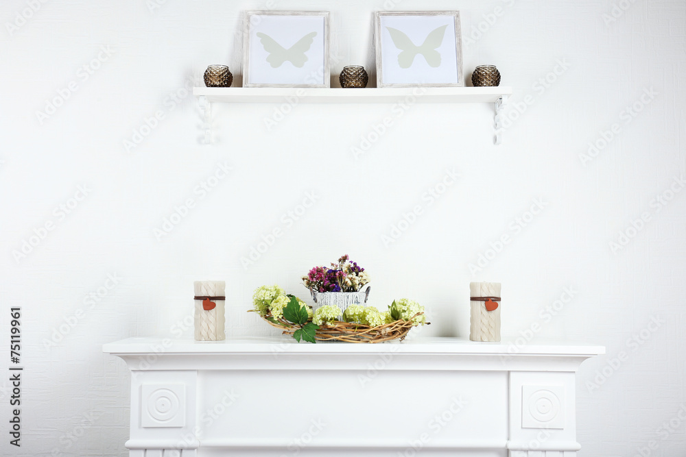 Stylish shelves with candles and frames