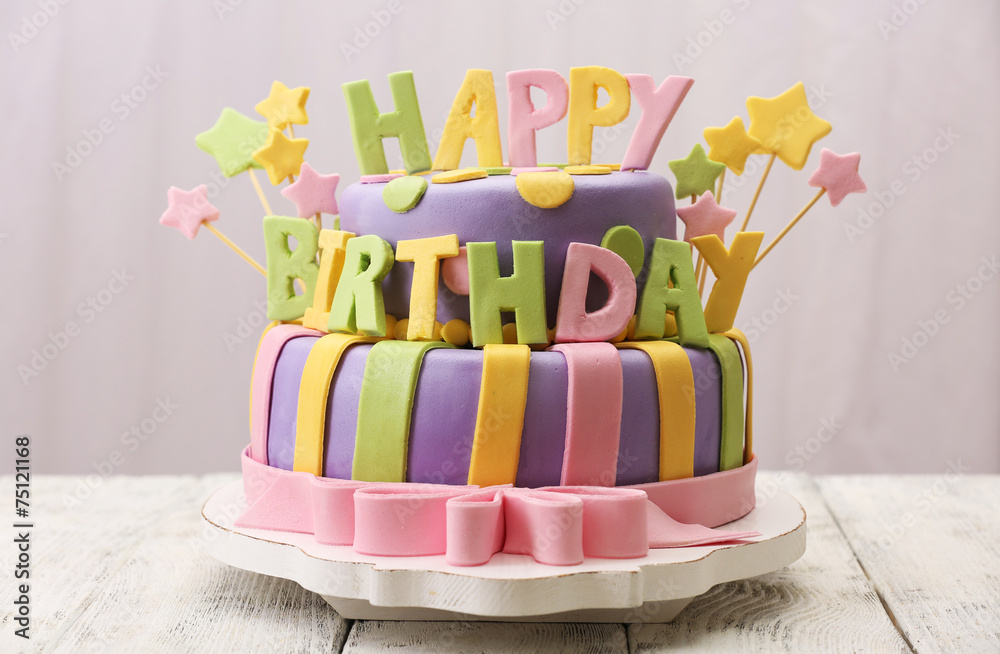 Delicious birthday cake on table on light background