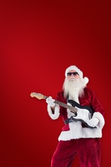 Poster - Composite image of santa claus plays guitar with sunglasses
