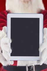 Poster - Composite image of santa presents a tablet pc