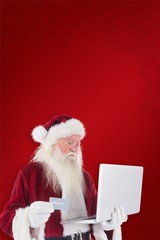 Aufkleber - Composite image of santa pays with credit card on a laptop