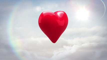 Red heart turning and exploding over blue sky