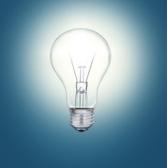 A light bulb shines in the darkness bright light