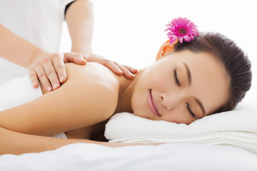 young woman in spa salon getting massage