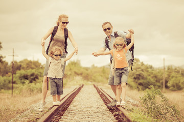 Wall Mural - Happy family walking on the railway at the day time.