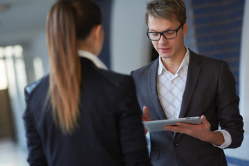 young business woman and businessman in the hallway