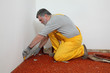 © sima - Home renovation, worker remove carpet from room floor