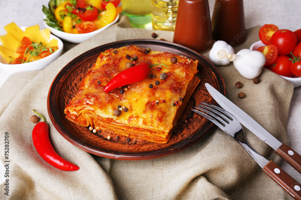 Portion of tasty lasagna on table