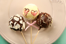 Tasty Cake Pops On Plate, On Wooden Table