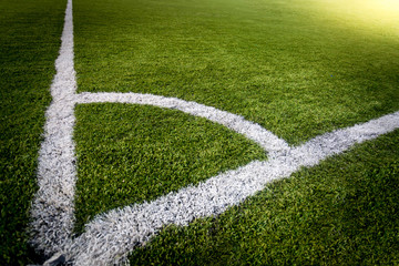 corner of soccer field lit by sun rays