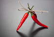 red hot chili peppers tied twine against dark background